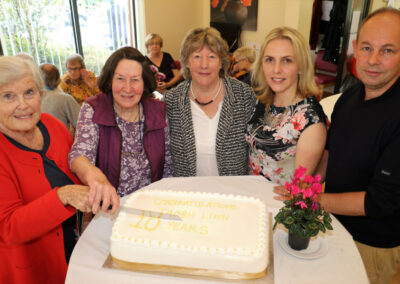 5 people Cutting a ceremonial cake