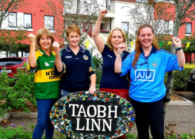 staff in dublin and Kerry colours at taobh linn sign