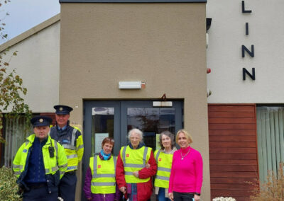 Garda and service users outside centre